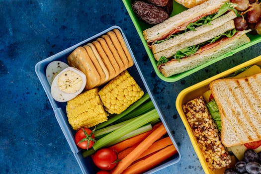 Colorful lunchboxes featuring sandwiches, vegetables, and snacks for healthy eating.