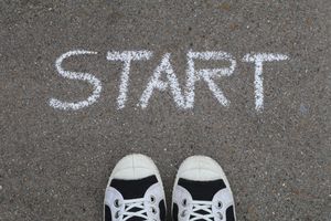 pexels-photo-2646531-2646531 Close-up of sneakers and a 'START' chalk drawing on pavement, symbolizing new beginnings.